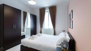 En eller flere senge i et værelse på Liberty Home