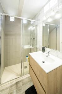 uma casa de banho com um chuveiro, um lavatório e uma cabina de duche. em Apartamento ALMA con terreno privado y parking compartido - a 800m de Playa Poniente em Benidorm
