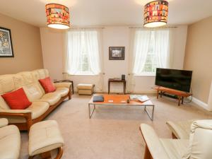 a living room with a couch and a table at The Mill in Buxton