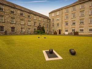 a large building with a field with balls on it at The Mill in Buxton