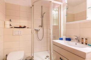 a bathroom with a shower and a toilet and a sink at Haus der Gemütlichkeit in Konstanz +11 photos