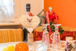 a bottle of wine sitting on a table with a heart shapedasuring at Haus der Gemütlichkeit in Konstanz