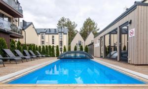 a swimming pool in the middle of a building at Apartamentai Čiki puki 2 aukštas in Palanga