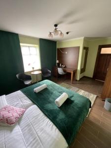 a bedroom with a bed with two pillows on it at Agroturystyka Siekierczyn 249 - Lubań 7 km in Siekierczyn