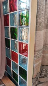 a glass block wall with different colored glasses at rincones con encanto 