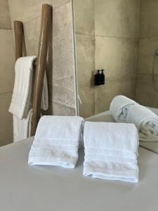 two towels sitting on a table in a bathroom at À Espera - Turismo Rural,Melides in Melides
