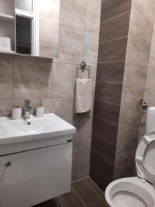 a bathroom with a white sink and a toilet at Džoni in Sarajevo