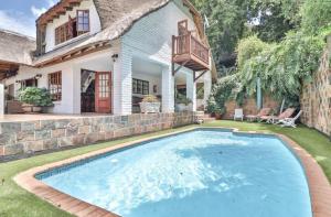 a house with a swimming pool in the yard at 147@ Simon Bekker Kosmos in Hartbeespoort