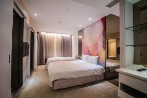 Voodi või voodid majutusasutuse Artinn藝築文旅-台北站前館 toas