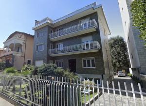 an apartment building with a fence in front of it at R39 Modern Apartment with Private Parking in Milan