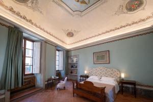 a bedroom with a bed and a coffered ceiling at Delcorto Suites in Montepulciano