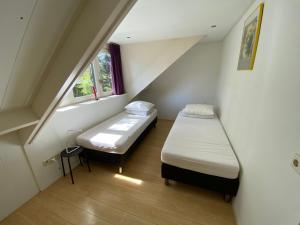 Ένα ή περισσότερα κρεβάτια σε δωμάτιο στο Casa Vogelenzang