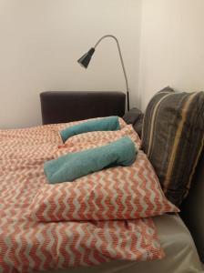 a bed with two pillows and a lamp on it at Student standard apartment in Krakow