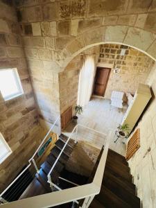 an overhead view of a room with a stone wall at Id-dar Taz-zija Holiday Home including pool & garden in Siġġiewi