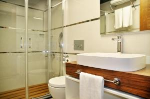 a bathroom with a sink and a toilet and a shower at Avin Hotel in Izmir
