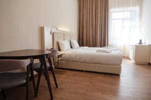 a hotel room with a bed and a table at KUMA Hotel Gyumri in Gyumri