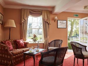 a living room with a couch and chairs and a table at Corse Lawn House Hotel in Corse