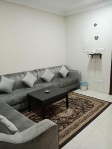 a living room with a couch and a coffee table at برج سما للشقق المفروشة in Jeddah