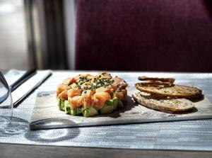 a plate of food with shrimp and bread on a table at Hotel Ankaa - Adults Only in Porto Cristo