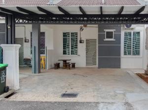a patio with awning and a picnic table on a house at MAS'homestay perlis in Kangar