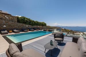 a villa with a swimming pool and a view of the ocean at Villa Cataleya 2 PRIVATE POOL in Fanari