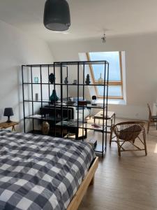 a bedroom with a bed and a table and a window at PANORAMA du LOC in Locmiquélic