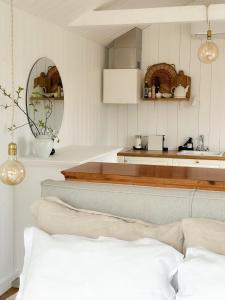 a kitchen with white walls and a couch in a room at Ragnar Glamp Pitrags Lux in Pitragutsiyeme