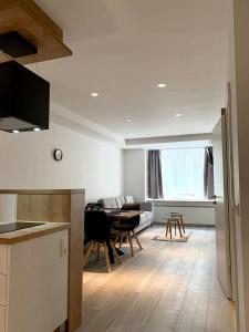 a kitchen and living room with a table and chairs at Hotel La Fleur in Überlingen