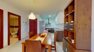 a kitchen with a table and a dining room at Edificio Galerias in Lorca