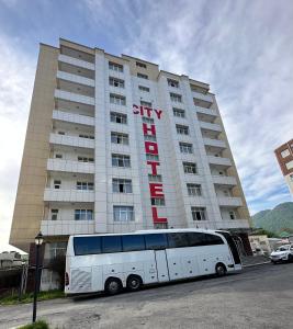a bus parked in front of a large building at Gabala Tufandag City Hotel in Gabala