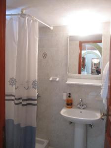 a bathroom with a sink and a shower curtain at Studios Irene in Skala +37 photos