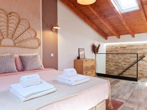 a bedroom with a bed with two towels on it at CASA OFICINA - Praia & Centro (300m) - WiFi - AC in Carvoeiro
