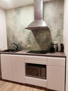 a kitchen with a sink and a stove at Amrai in Ventspils +39 photos