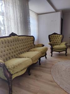 a living room with a couch and two chairs at Amrai in Ventspils