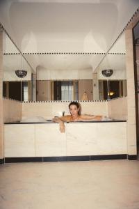 a woman sitting in a bath tub in front of a mirror at Sommerro in Oslo