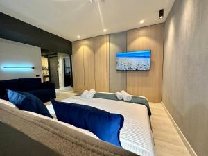 a bedroom with a bed and a tv on a wall at Luxury by Magic Apartments in Bucharest +5 photos