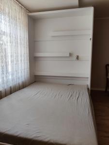 a bed in a room with a window at Amrai in Ventspils