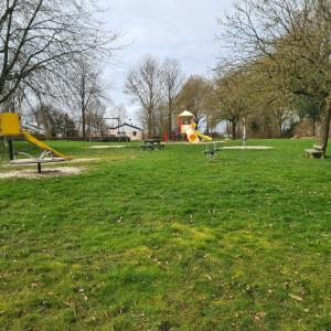 a park with a playground with a yellow slide at Heuvel 35 in Simpelveld
