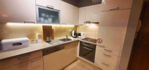 a small kitchen with a sink and a microwave at Villa Salena with pool Slatine in Slatine