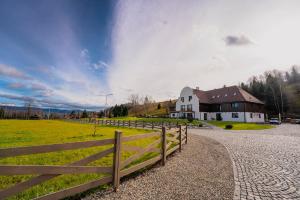 a wooden fence in front of a white house at Timian Chalet in Miercurea-Ciuc