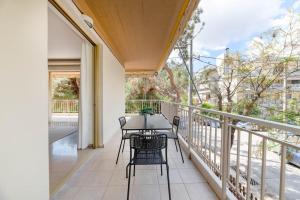 a patio with a table and chairs on a balcony at Captivating 2BR Apartment in Chalandri by UPSTREET in Athens