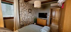 a bedroom with a bed and a tv in a room at Villa Salena with pool Slatine in Slatine +13 photos