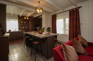 a kitchen with a large island in a room at Boutique Villa Gyula in Gyula