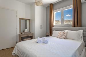 a bedroom with a bed with two towels on it at Stelianas House Ground Floor Apartment with Private Pool in Lygaria +55 photos