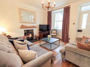 a living room with a couch and a fireplace at Holmdale in Ambleside