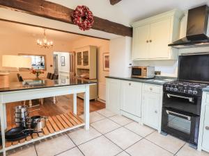 a kitchen with white cabinets and a counter top at Holmdale in Ambleside