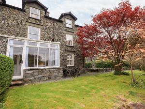 a house with a large window and a yard at Holmdale in Ambleside