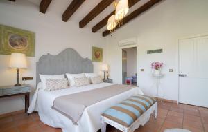 a bedroom with a large white bed with a large headboard at Font in Mancor del Valle