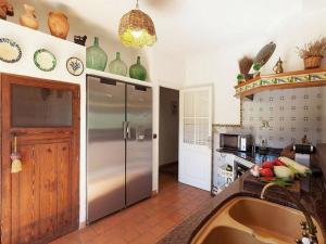 a kitchen with a large stainless steel refrigerator at Font in Mancor del Valle