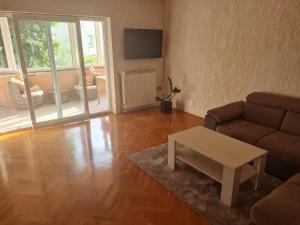 a living room with a couch and a coffee table at Apartment Donna Rijeka in Rijeka
